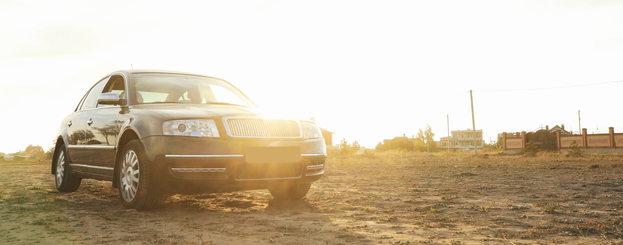 Black sedan car against sunlight, space for text